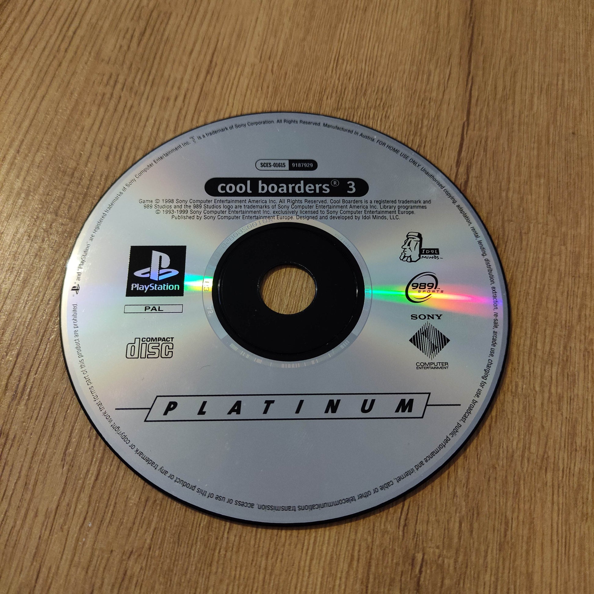 PlayStation Platinum disc on a wooden surface